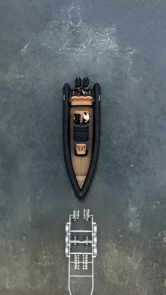 Slide: The Image of Aerial view of 2022 Roughneck 1010 boat on water near dock. - 16