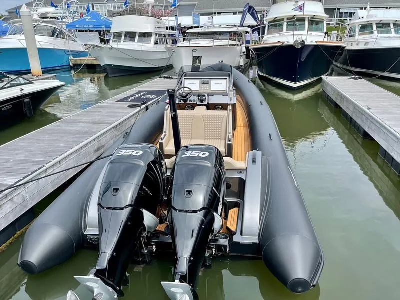 Slide: The Image of 2022 Roughneck 1010 boat with dual 350 engines docked at a marina. - 4