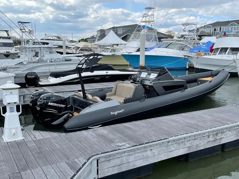 Slide: The Image of 2022 Roughneck 1010 boat docked, featuring a sleek design and Mercury engine. - 5
