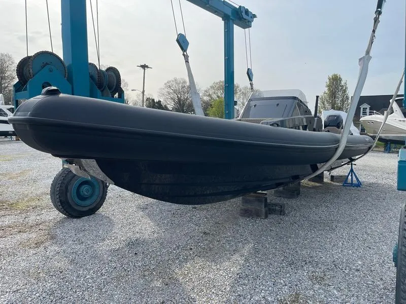 Slide: The Image of Roughneck 1010 boat, 2022 model, suspended on a lift in a boatyard. - 8