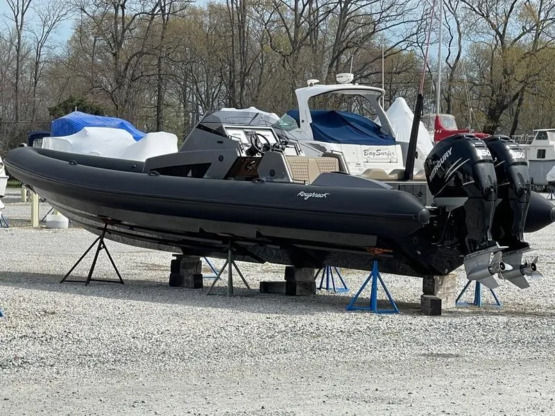 Slide: The Image of 2022 Roughneck 1010 boat on stands, parked outdoors in a marina setting. - 9