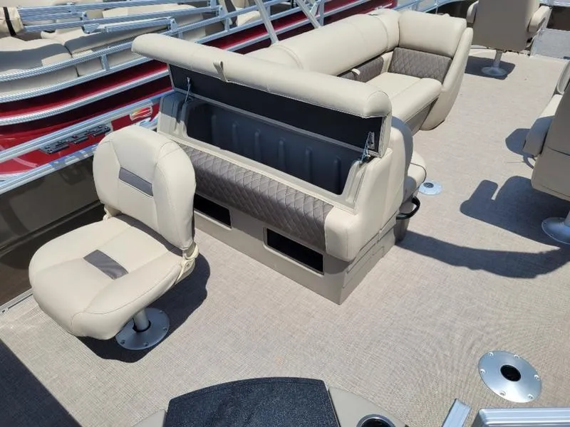 Slide: The Image of Sun Tracker SF 20 DLX 2025 pontoon boat interior with beige seating and storage compartments. - 10