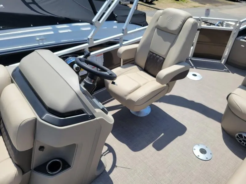 Slide: The Image of 2025 Sun Tracker SF 20 DLX boat interior with captain's chair and steering console. - 14