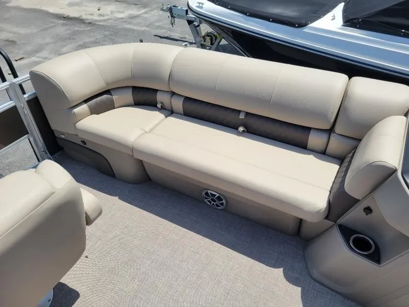 Slide: The Image of 2025 Sun Tracker SF 20 DLX pontoon boat with beige seating and spacious layout. - 15