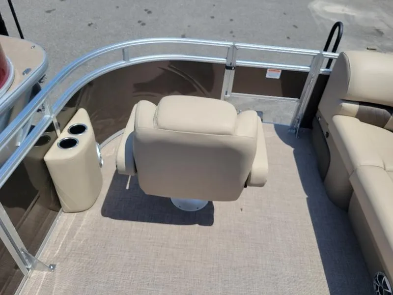 Slide: The Image of 2025 Sun Tracker SF 20 DLX boat interior with beige captain's chair and cup holders. - 16