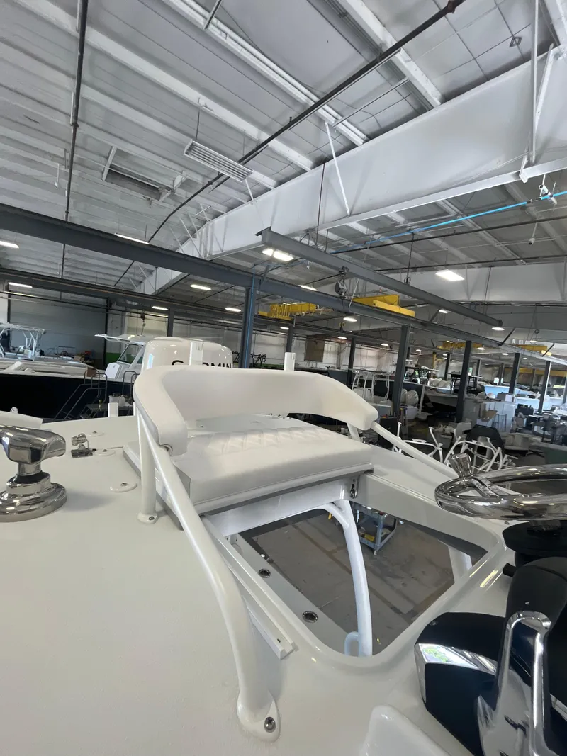 Slide: The Image of 2025 Yellowfin 26 Hybrid boat interior in a showroom. - 10