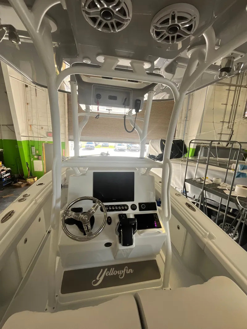 Slide: The Image of 2025 Yellowfin 26 Hybrid boat interior with advanced navigation system and steering console. - 4