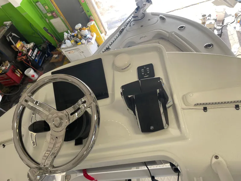 Slide: The Image of 2025 Yellowfin 26 Hybrid boat helm with steering wheel and controls. - 6