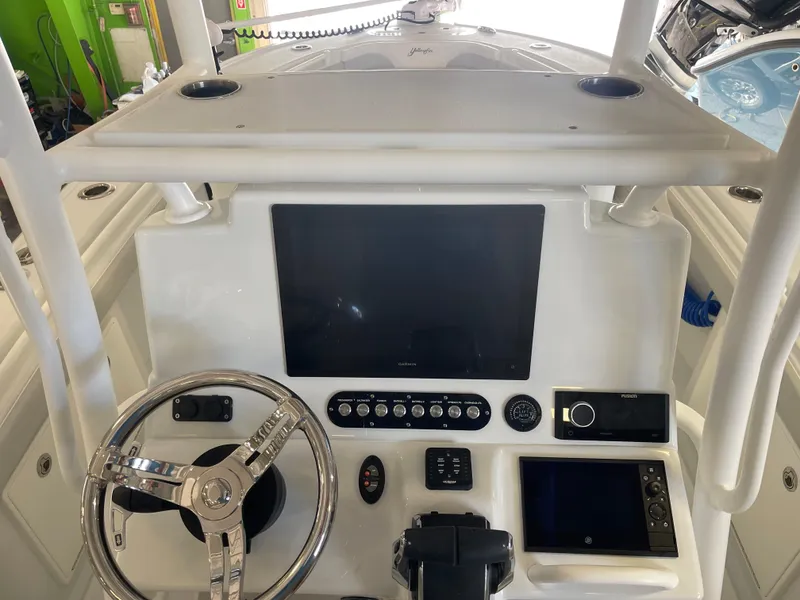 Slide: The Image of Control console of a 2025 Yellowfin 26 Hybrid boat with modern navigation equipment. - 7