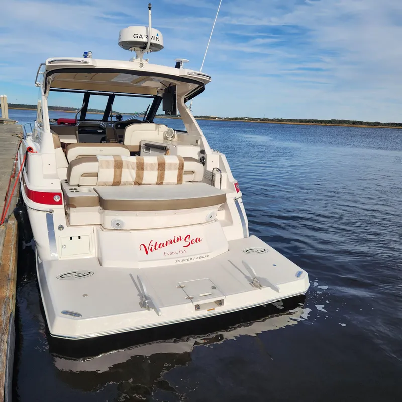 Slide: The Image of 2018 Regal 35 Sport Coupe docked, rear view with Vitamin Sea name. - 10