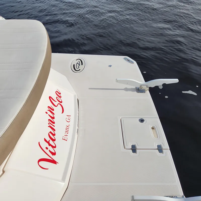Slide: The Image of 2018 Regal 35 Sport Coupe boat named Vitamin Sea docked on water. - 12
