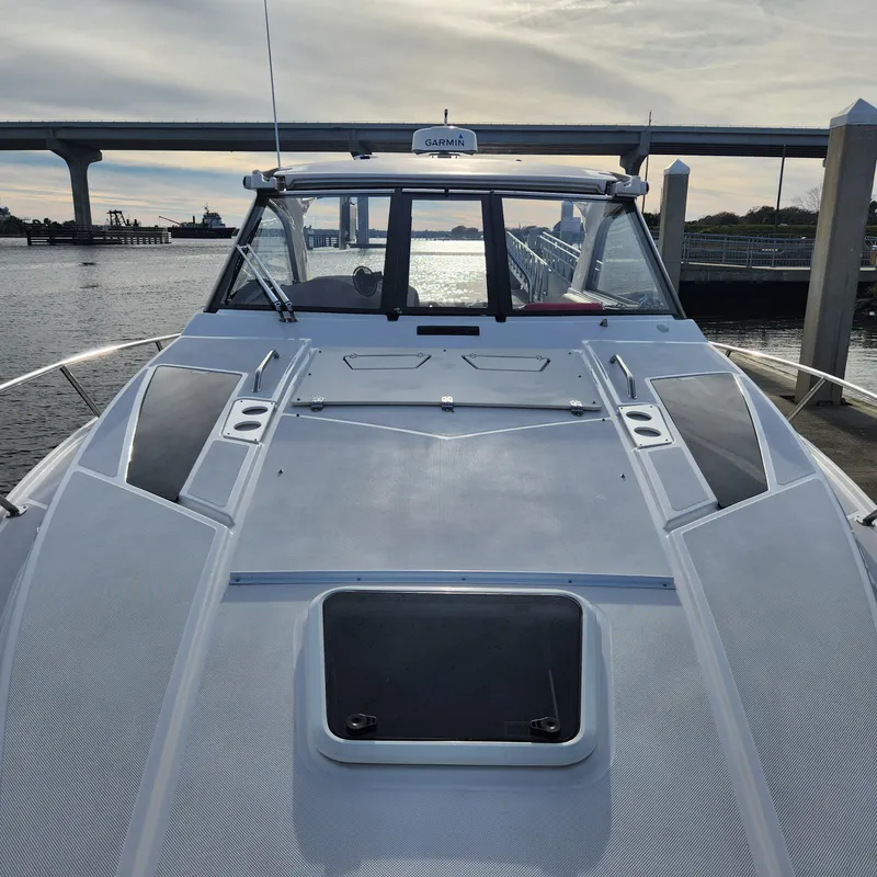 Slide: The Image of 2018 Regal 35 Sport Coupe docked at marina with bridge in background. - 17