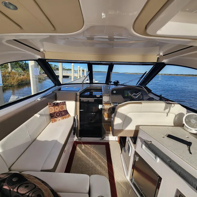 Slide: The Image of Interior of a 2018 Regal 35 Sport Coupe yacht docked by the water. - 19