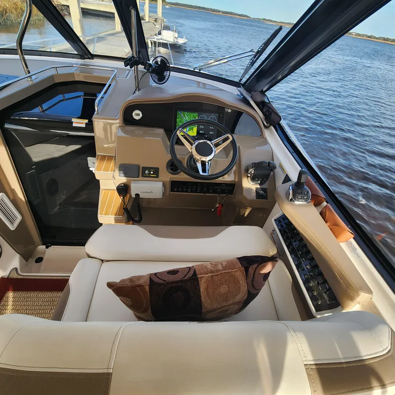 Slide: The Image of Cockpit of 2018 Regal 35 Sport Coupe with steering wheel, navigation system, and plush seating. - 21