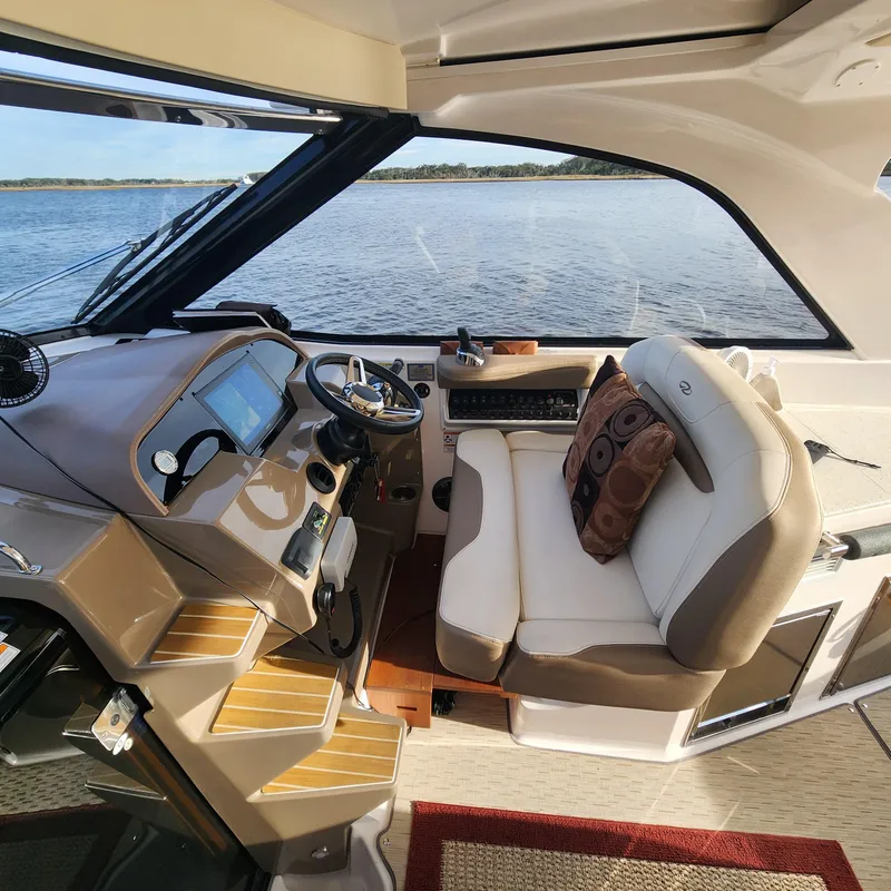 Slide: The Image of Interior helm of 2018 Regal 35 Sport Coupe with leather seating and navigation controls. - 22