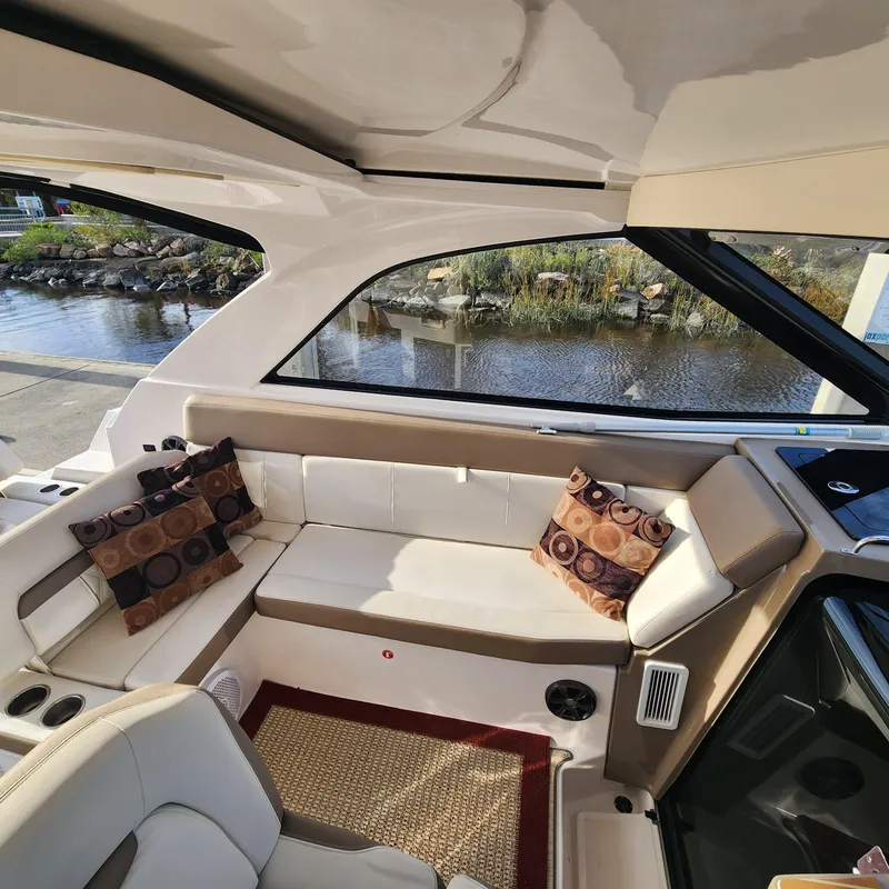 Slide: The Image of Interior of 2018 Regal 35 Sport Coupe with white seating and decorative pillows. - 23