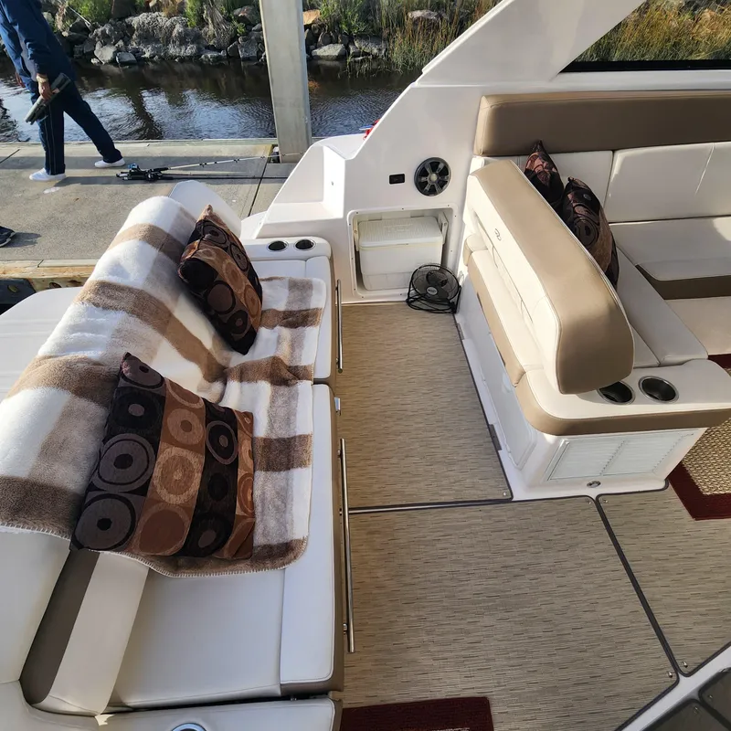 Slide: The Image of Interior of 2018 Regal 35 Sport Coupe with seating, pillows, and blanket. - 27