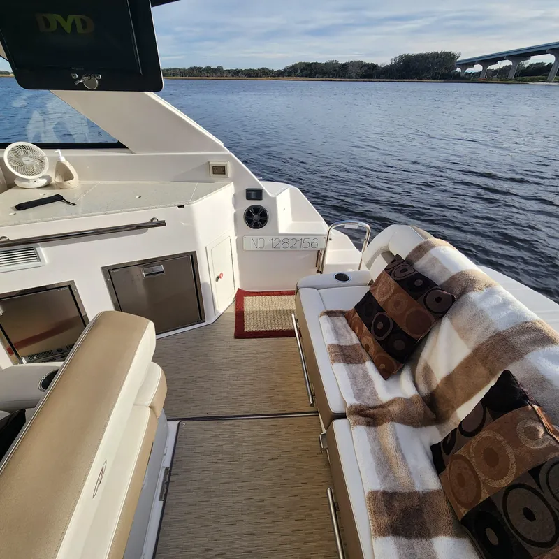 Slide: The Image of Interior of 2018 Regal 35 Sport Coupe boat with seating and water view. - 29