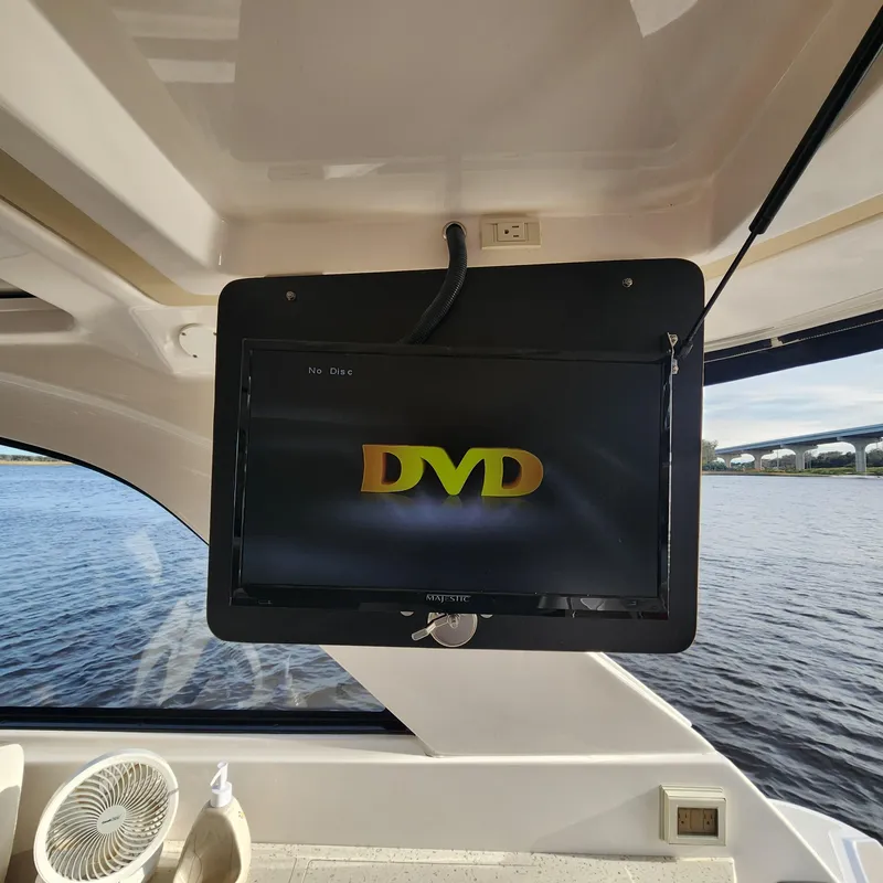 Slide: The Image of TV screen displaying DVD logo inside 2018 Regal 35 Sport Coupe boat. - 30