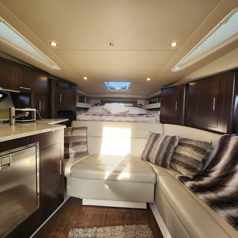 Slide: The Image of Interior of 2018 Regal 35 Sport Coupe with modern kitchen and cozy seating area. - 31