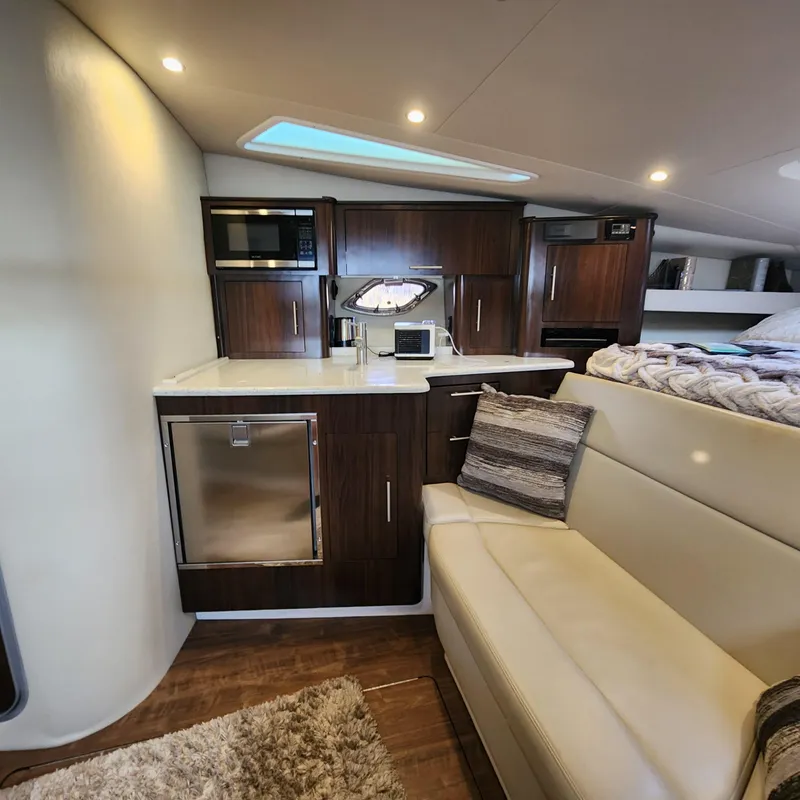 Slide: The Image of Interior of 2018 Regal 35 Sport Coupe with kitchenette and seating area. - 36