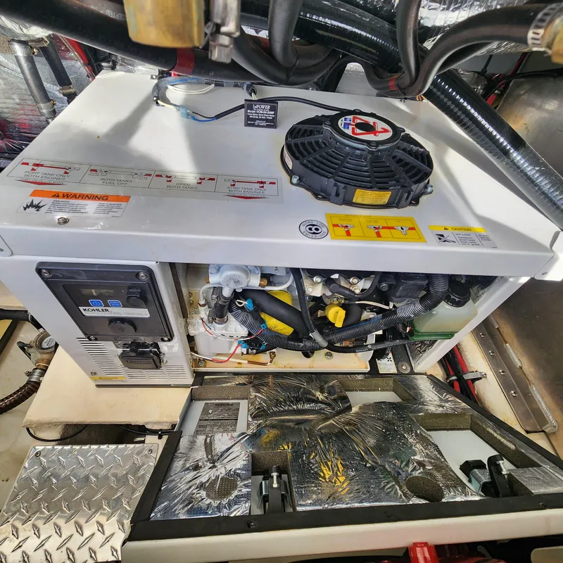 Slide: The Image of Engine compartment of a 2018 Regal 35 Sport Coupe with generator and wiring. - 43