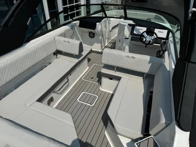 Slide: The Image of 2025 Sea Ray SDX 270 boat interior with white seating and modern dashboard. - 3