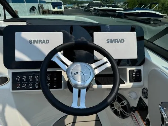 Slide: The Image of 2025 Sea Ray SDX 270 boat dashboard with Simrad displays and steering wheel. - 4