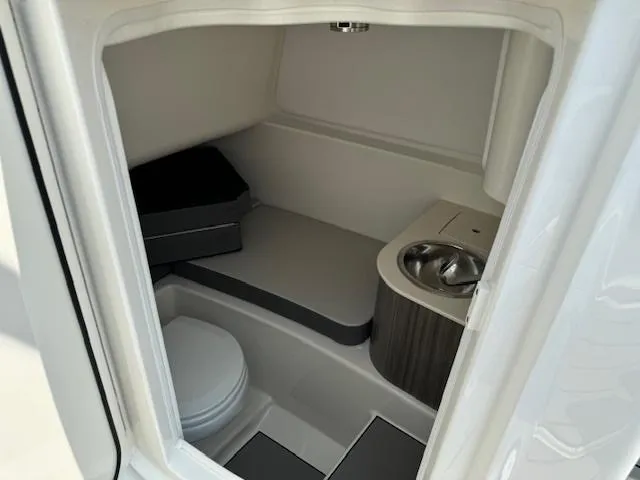 Slide: The Image of 2025 Sea Ray SDX 270 boat interior bathroom with toilet and sink. - 5
