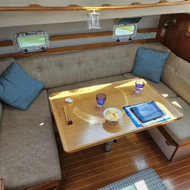 Slide: The Image of Cozy Nautilus Pilothouse 36 interior with table, cushions, and portholes, 1986 model. - 11