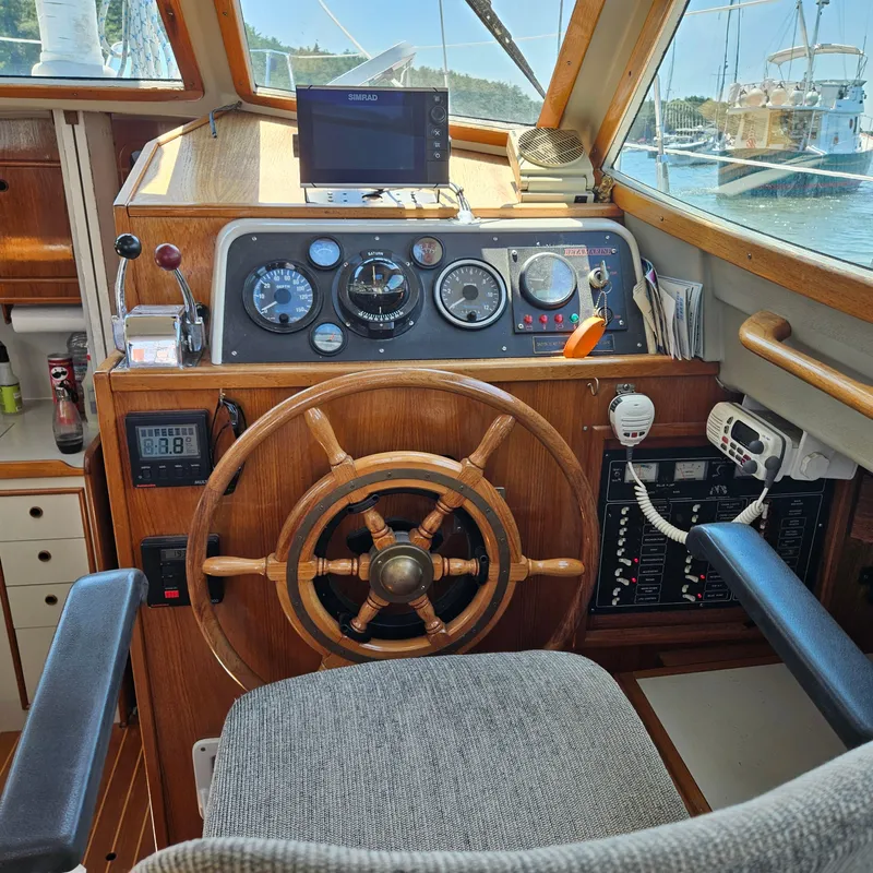 Slide: The Image of 1986 Nautilus Pilothouse 36 helm with wooden wheel and navigation instruments. - 13