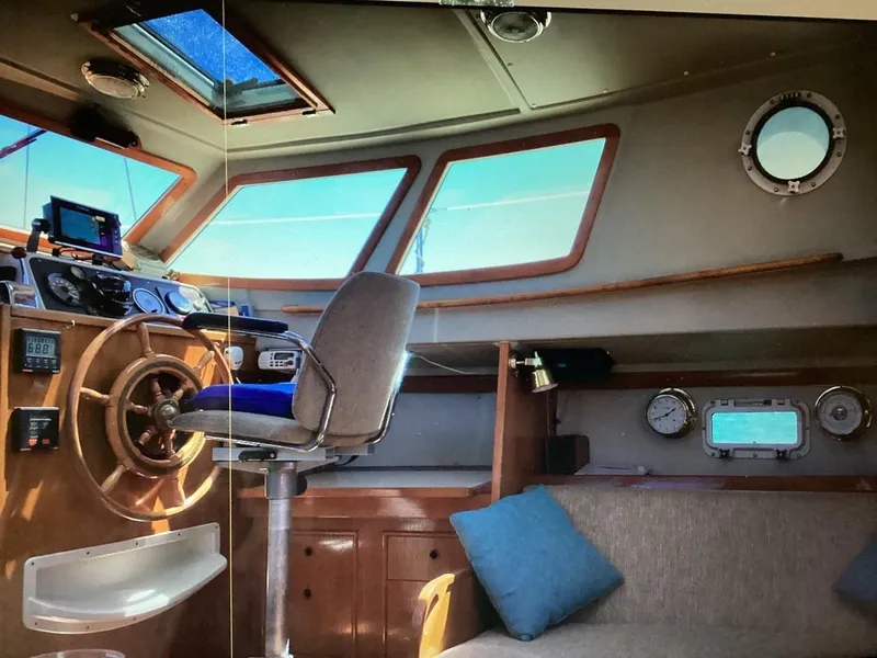 Slide: The Image of Interior of 1986 Nautilus Pilothouse 36 with helm, seating, and navigation instruments. - 14