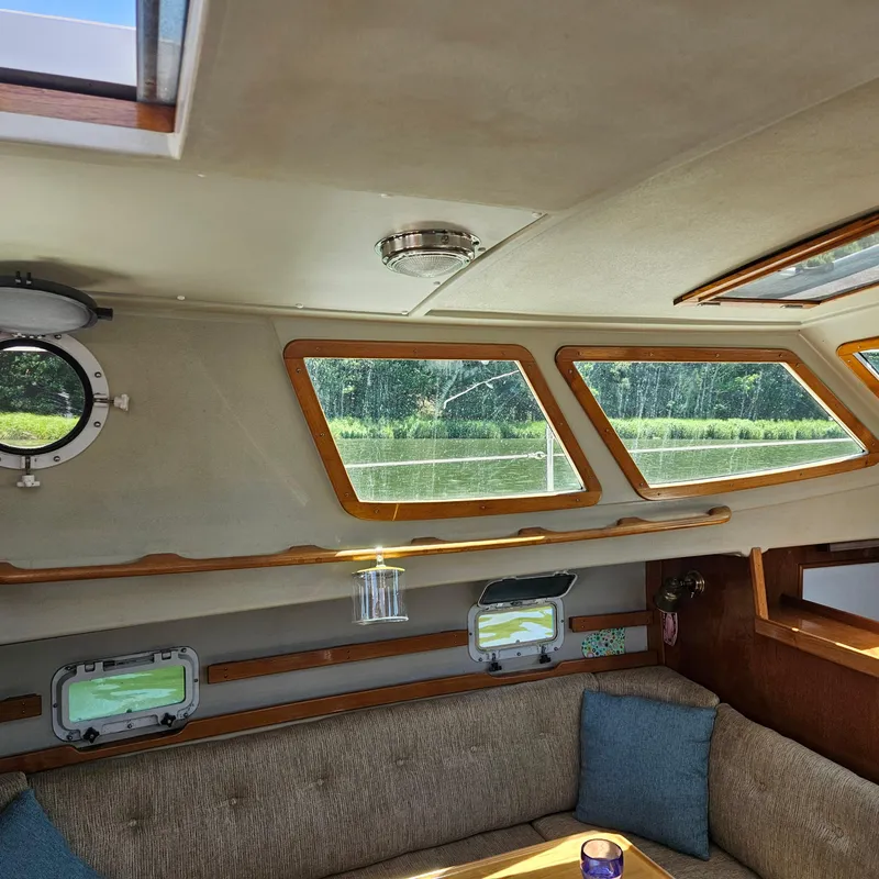 Slide: The Image of Interior of 1986 Nautilus Pilothouse 36, featuring cozy seating and large windows. - 16