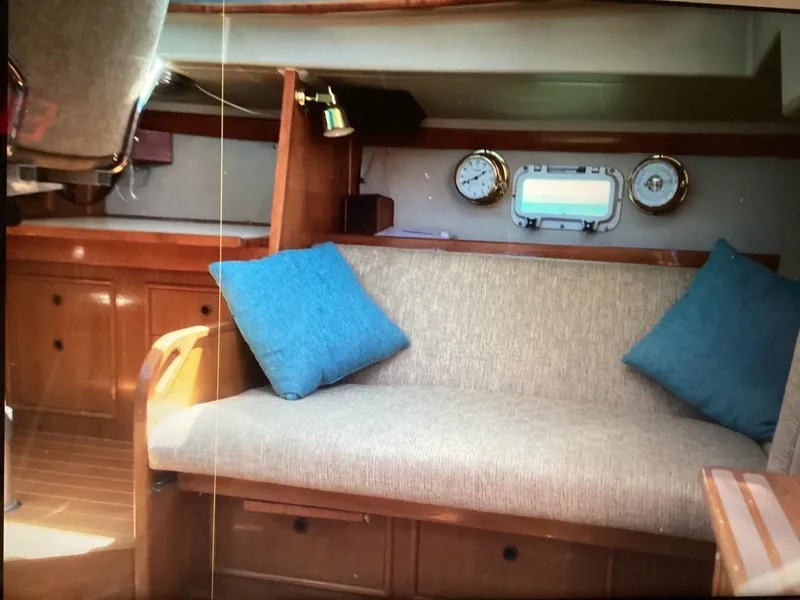 Slide: The Image of Interior of 1986 Nautilus Pilothouse 36 with sofa, blue cushions, and nautical decor. - 18