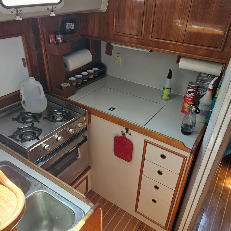 Slide: The Image of Compact kitchen in 1986 Nautilus Pilothouse 36 boat with stove, sink, and storage. - 22