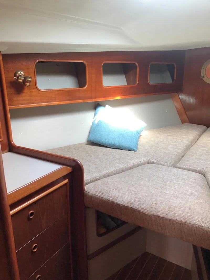 Slide: The Image of 1986 Nautilus Pilothouse 36 cabin interior with wood finish and cozy bedding. - 23