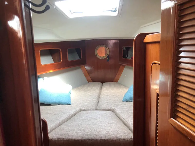 Slide: The Image of Interior cabin of 1986 Nautilus Pilothouse 36 with cozy bedding and wooden finish. - 24