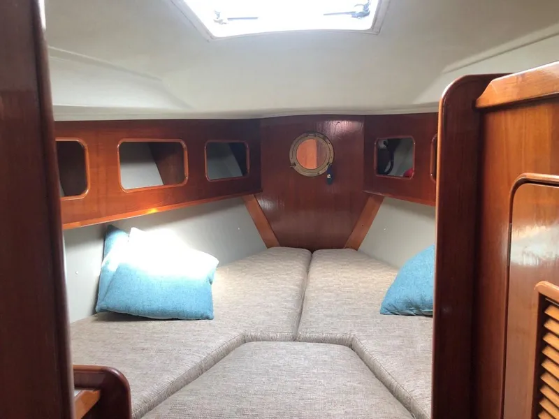 Slide: The Image of Cozy cabin interior of 1986 Nautilus Pilothouse 36 with wood paneling and cushions. - 25