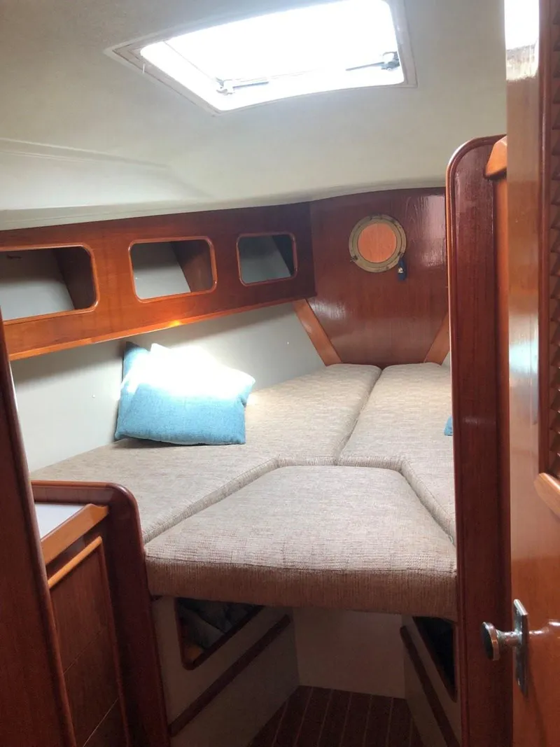 Slide: The Image of Cozy cabin interior of 1986 Nautilus Pilothouse 36 with wooden accents and skylight. - 26