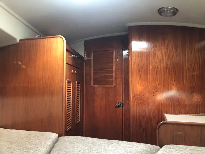 Slide: The Image of Interior of 1986 Nautilus Pilothouse 36 with wooden cabinetry and cozy seating area. - 28