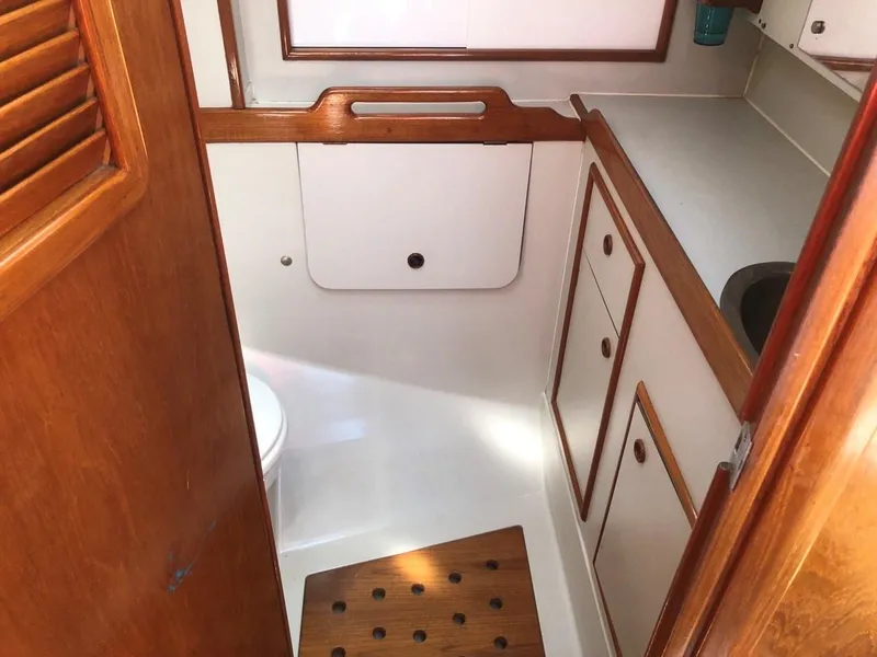 Slide: The Image of 1986 Nautilus Pilothouse 36 bathroom with wooden accents and white cabinetry. - 29