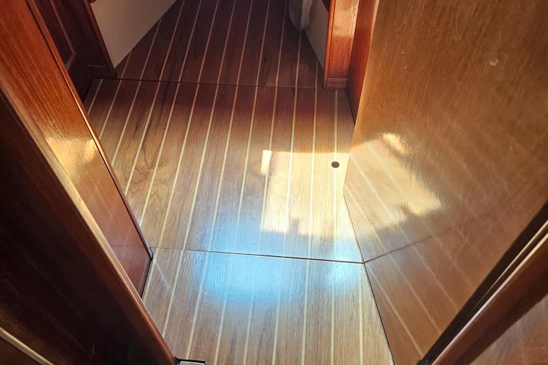 Slide: The Image of Wooden interior flooring of 1986 Nautilus Pilothouse 36 boat, showcasing natural light. - 33