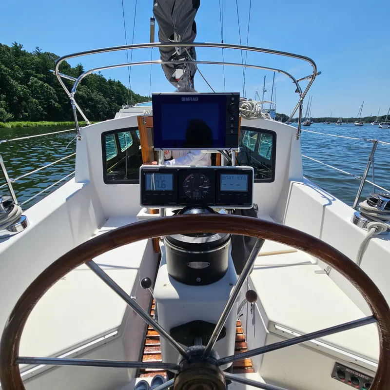 Slide: The Image of 1986 Nautilus Pilothouse 36 sailboat cockpit with steering wheel and navigation instruments. - 34
