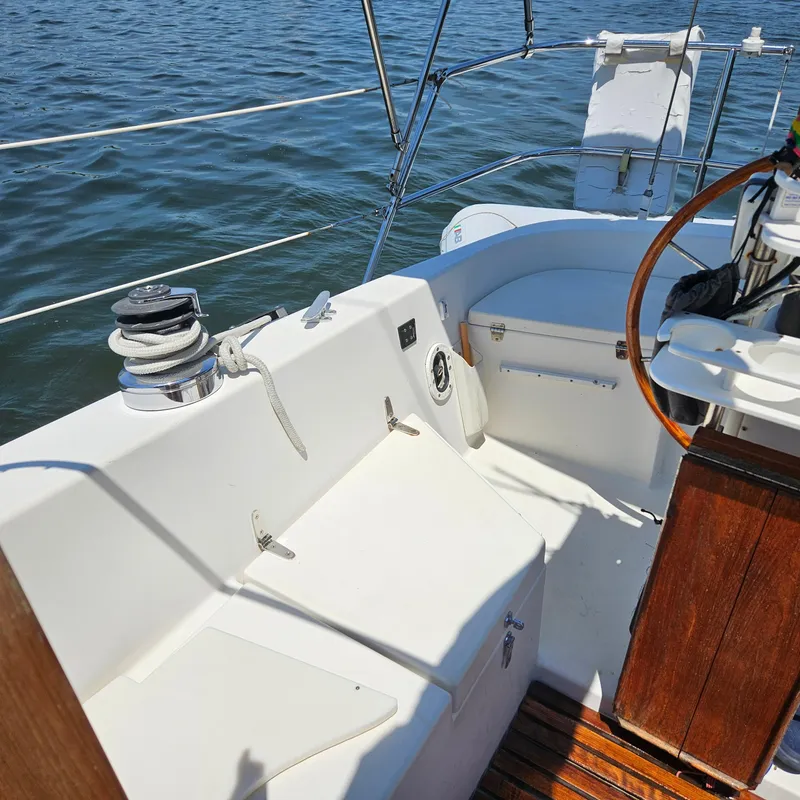 Slide: The Image of 1986 Nautilus Pilothouse 36 sailboat cockpit with wooden accents and ocean view. - 39