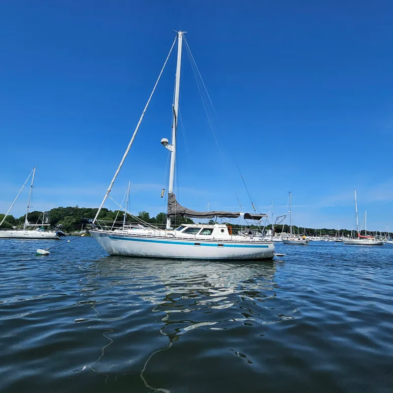 Slide: The Image of 1986 Nautilus Pilothouse 36 sailboat on calm water under clear blue sky. - 4