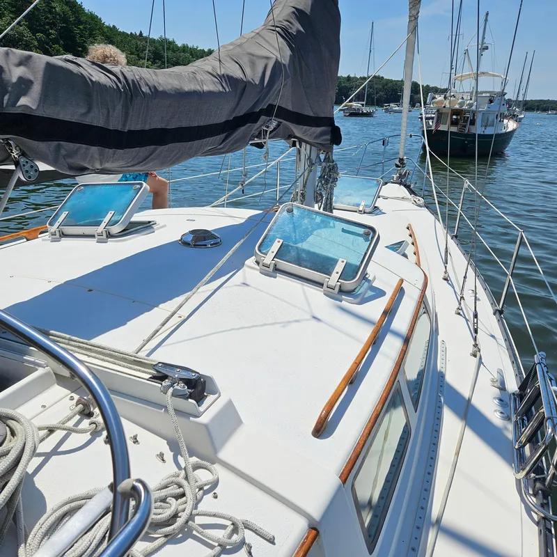Slide: The Image of 1986 Nautilus Pilothouse 36 sailboat deck with open hatches on a sunny day. - 43