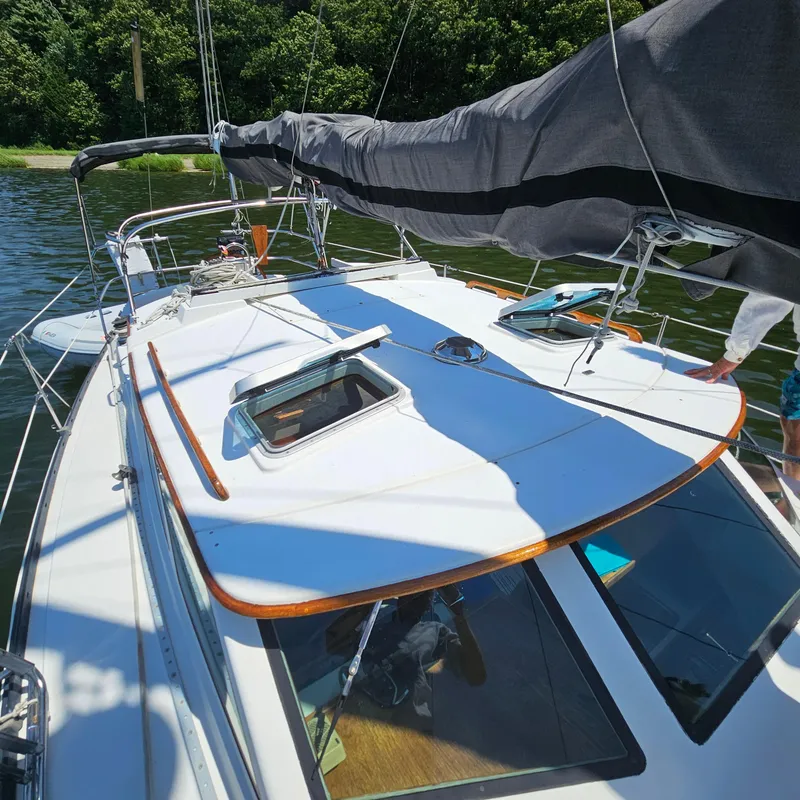 Slide: The Image of 1986 Nautilus Pilothouse 36 sailboat on calm water, featuring deck and rigging. - 45