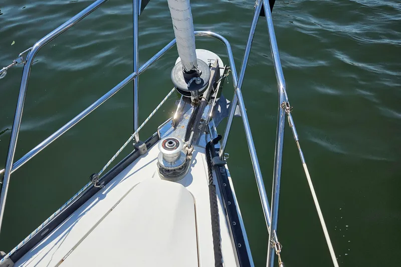 Slide: The Image of Bow of 1986 Nautilus Pilothouse 36 sailboat with winch and railing on calm water. - 49