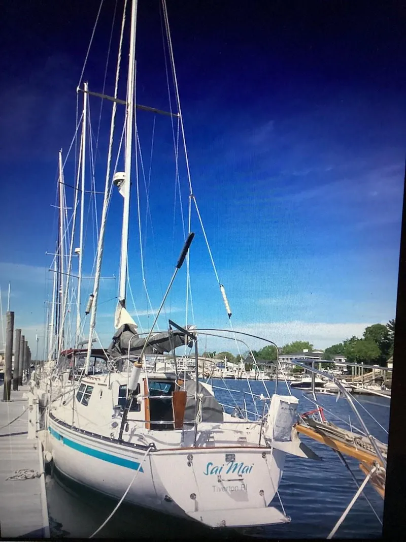 Slide: The Image of 1986 Nautilus Pilothouse 36 sailboat docked at marina under clear blue sky. - 7