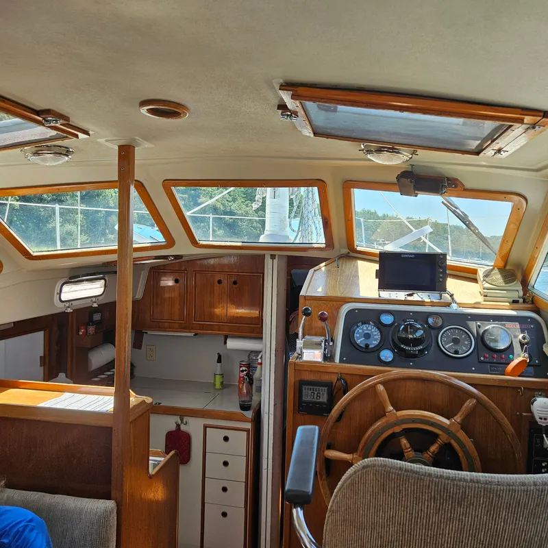 Slide: The Image of Interior of 1986 Nautilus Pilothouse 36, featuring helm and wooden cabinetry. - 8